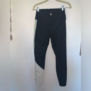 Peloton black leggings with silver stars.